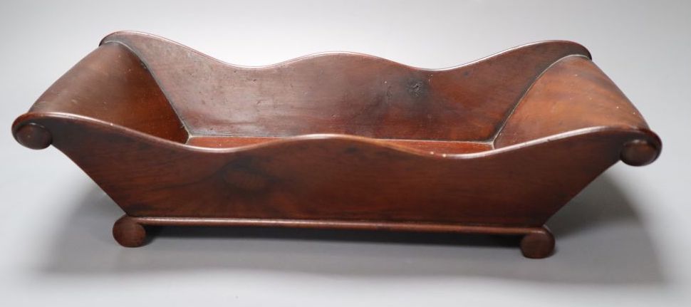 A Victorian mahogany cheese coaster, with scroll ends, 36 x 19cm